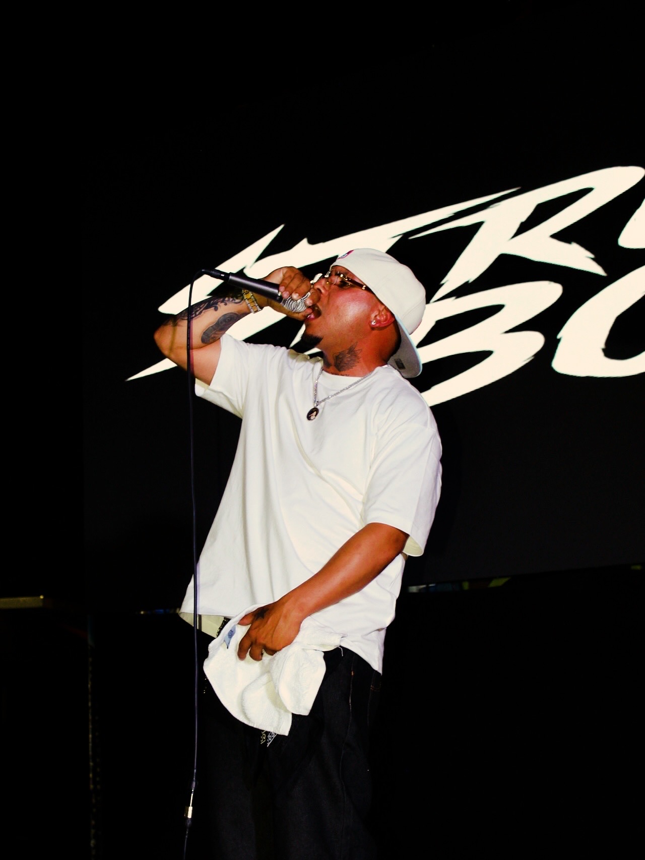 Close performance photograph of an artist singing on stage by LMDP